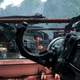 A screenshot from Crysis Remastered depicting the player character holding a rocket launcher, aiming at some enemies in the distance.